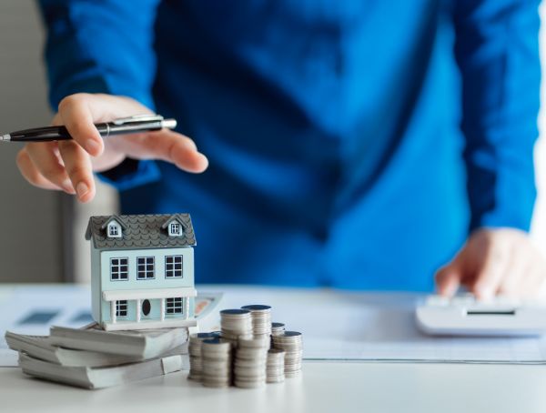 Saving Money for Real Estate Investment with with Stack of Money
