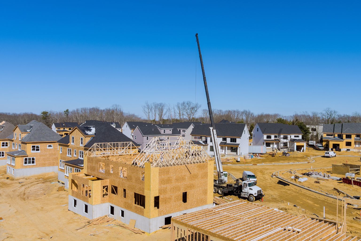 Unfinished subdivision incomplete neighbourhood housing construction site aerial view